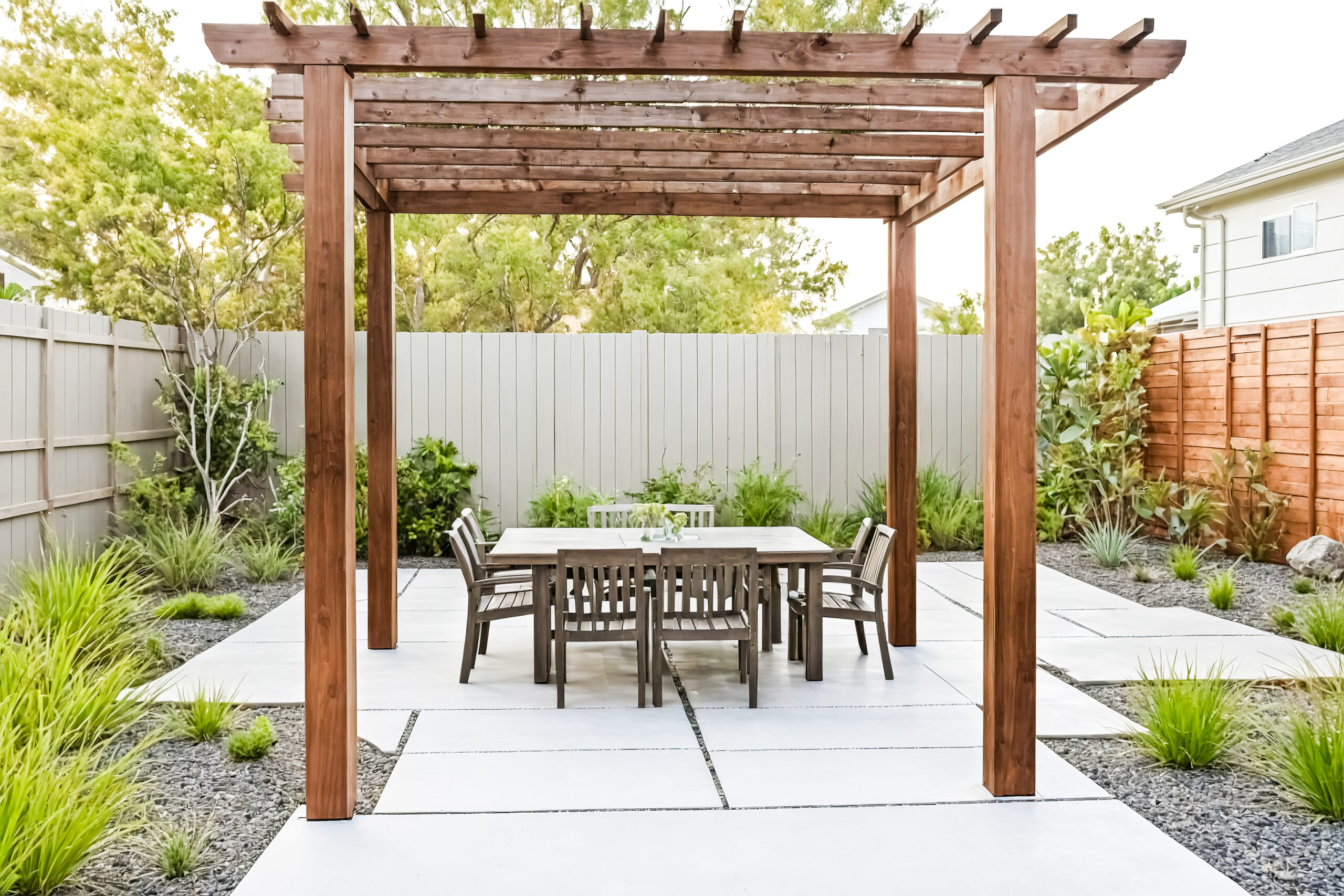 concrete patio with dinning table under a pergola